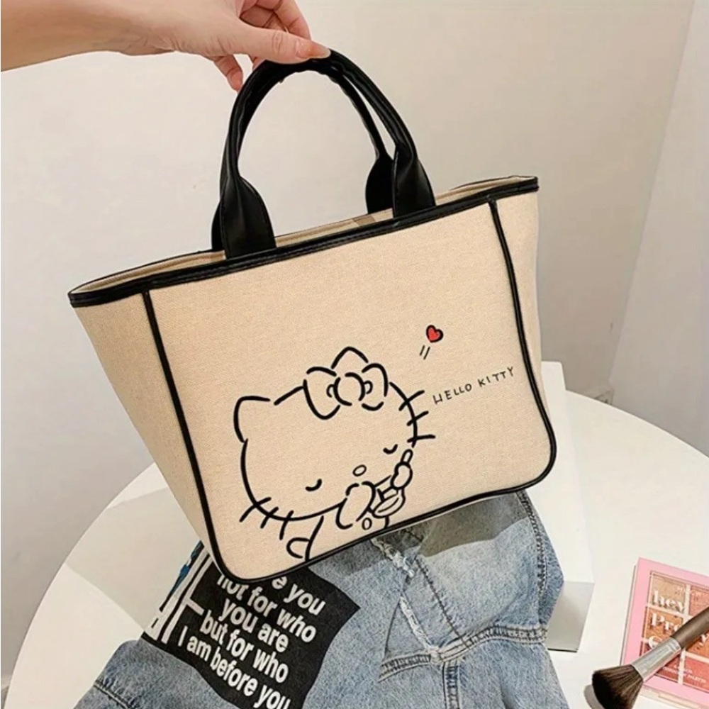 Hello Kitty beige canvas tote with faux leather handles.
